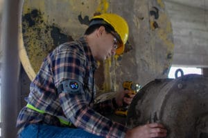 Image of a worker using a Sentinel sensor while on the job.